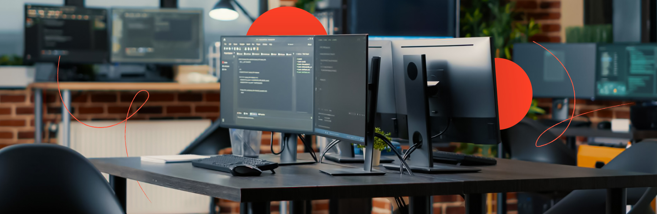 A workplace in an open-space office with several PC screens on each table