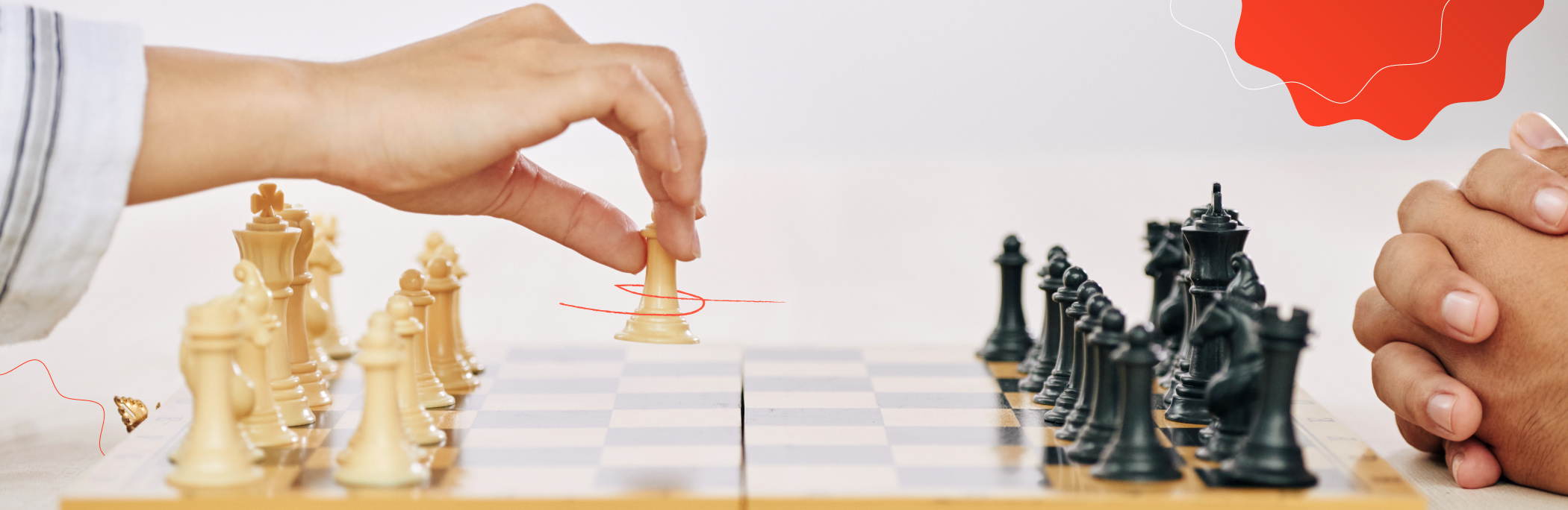 A chessboard with black and white figures arranged and two people playing, only their hands are visible